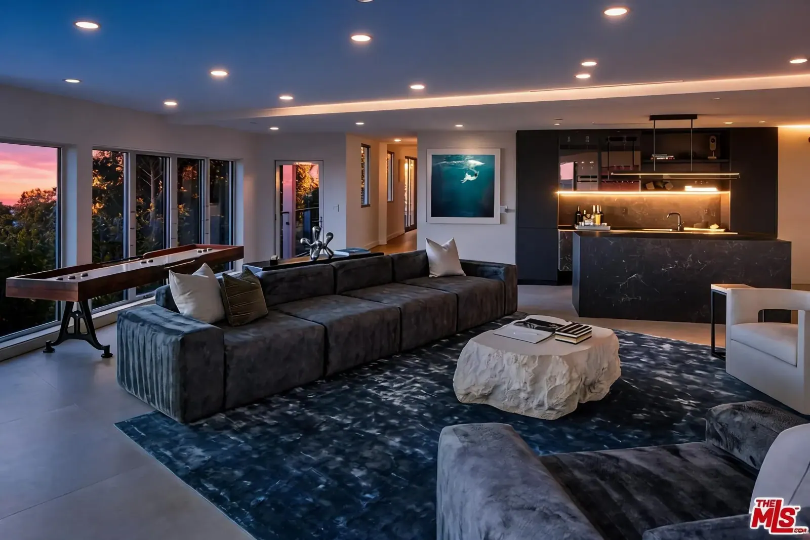 Media lounge with sectional, bar and shuffleboard table