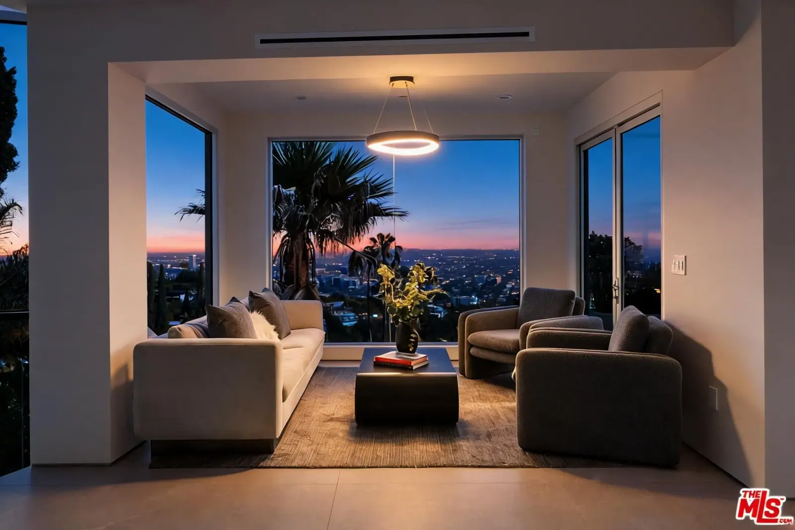 Sitting room with halo pendant and city view