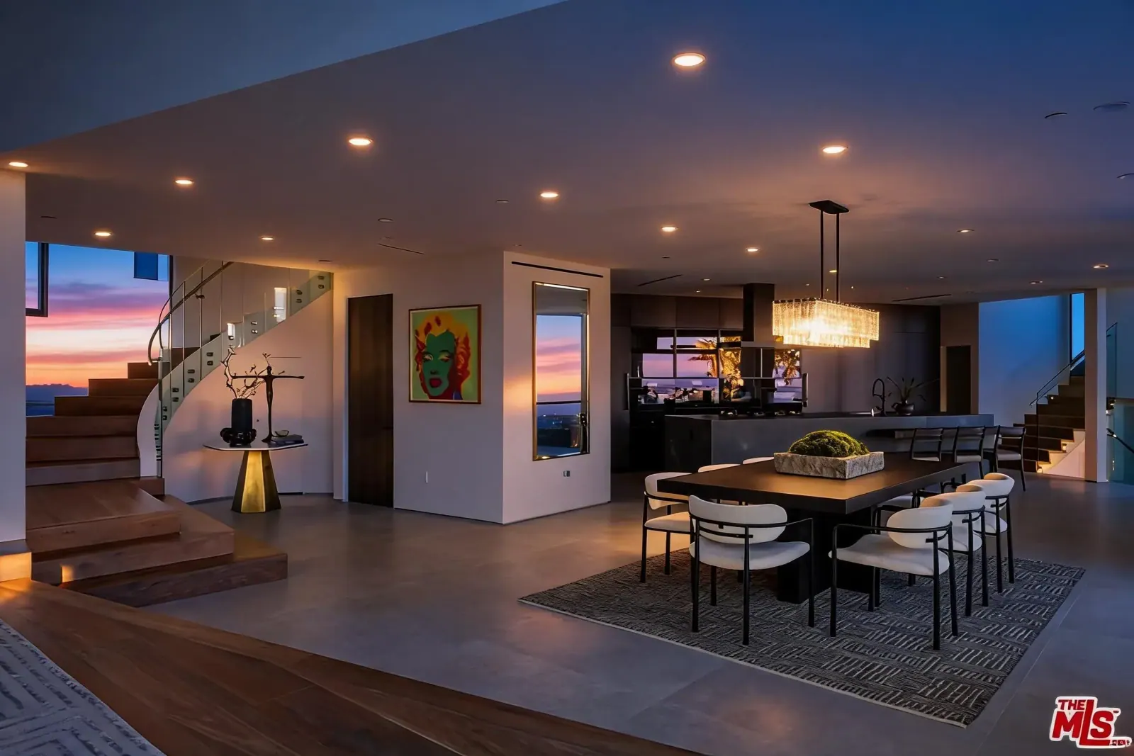Open dining area and floating stair at sunset