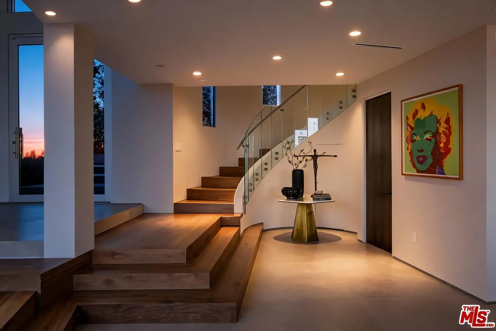 Entry foyer with floating wood and glass staircase