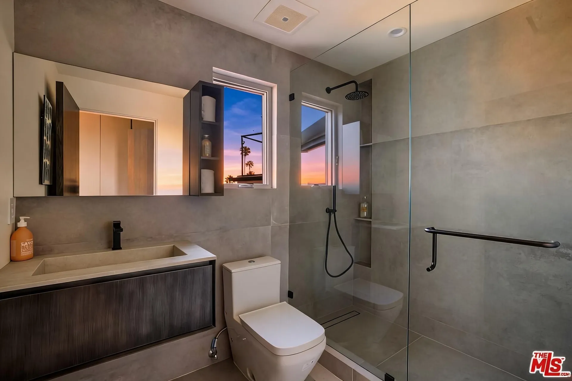 Guest bathroom with concrete-look tile, floating vanity and walk-in shower