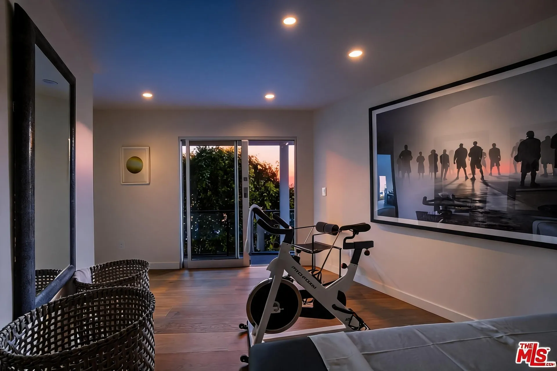 Fitness studio with stationary bike, woven baskets and garden door